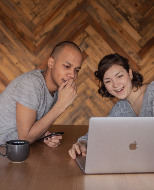 Male and female student looking at laptop